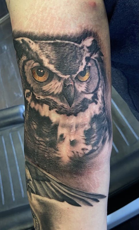 25 black and gray realistic owl tattoo arm