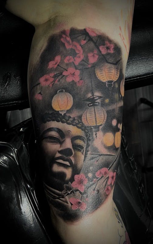 32 Buddah tattoo arm.
