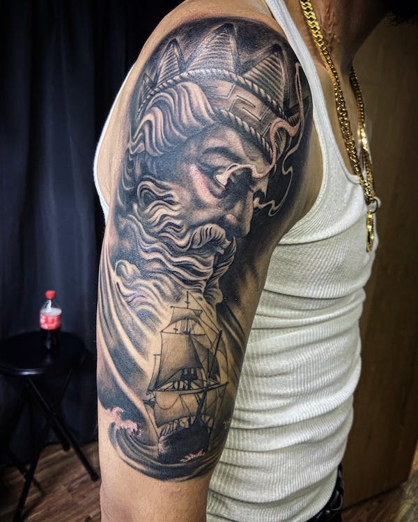 4 black and gray Zeus tattoo arm.