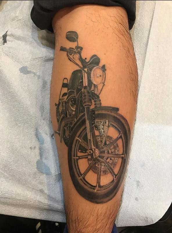 1 Matt-black and gray realistic motorcycle tattoo on leg