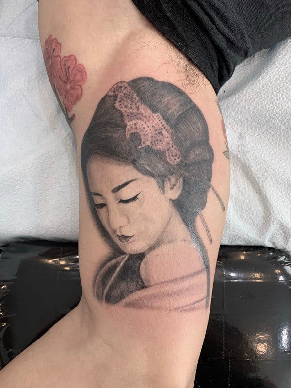 16Matt-black and gray realistic geisha tattoo on arm