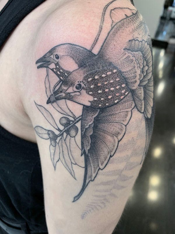 7Matt-black and gray realistic bird tattoo on arm