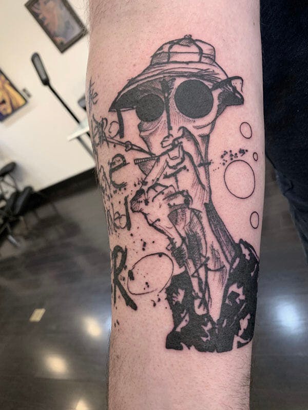 9Matt-black and gray Hunter Thompson tattoo on arm